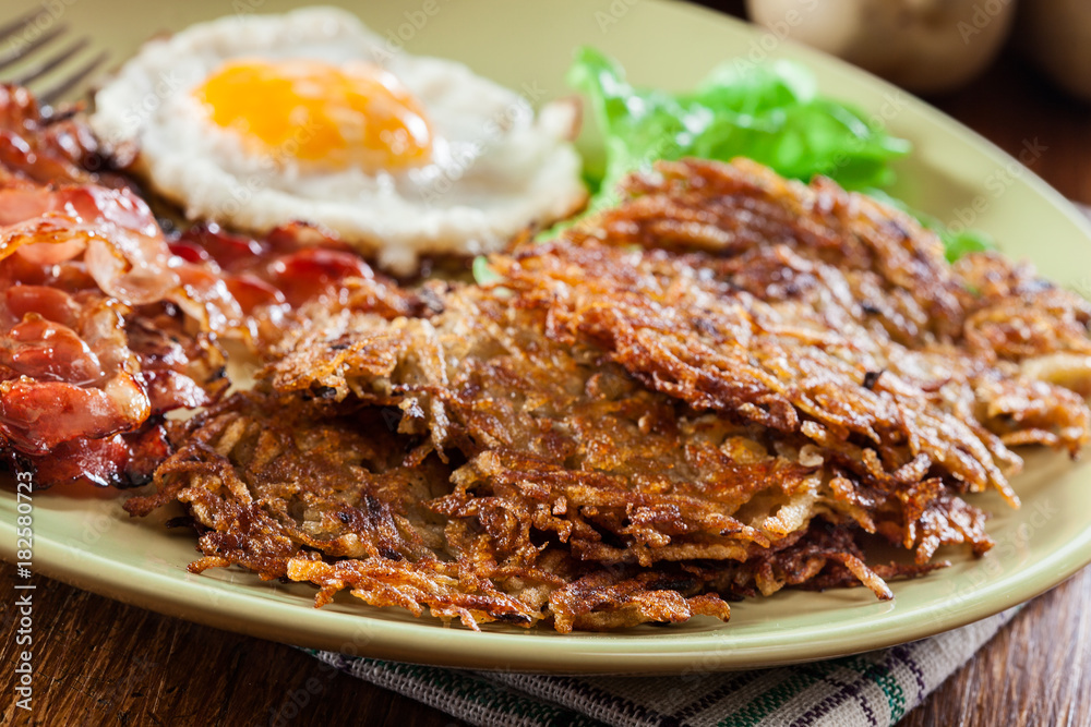 Hash browns. Potato pancakes with crispy fried bacon and fried egg Hash browns. Potato pancakes with crispy fried bacon and fried egg