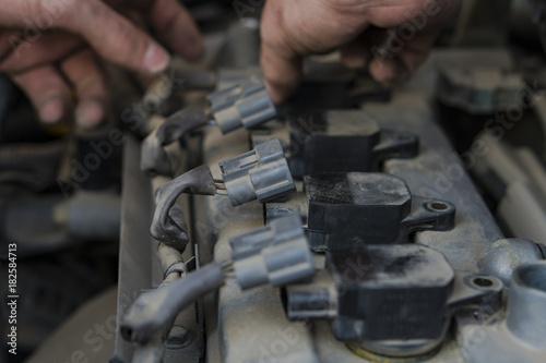 Car engine repair. Replacing the spark plugs in the engine. photo