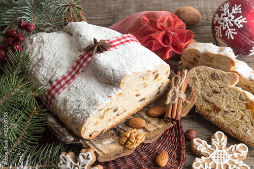 Traditional Christmas dresden cake stollen with candied fruits and almonds. Christmas New Year decoration.