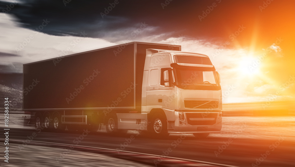 Large freight truck driving at sunset