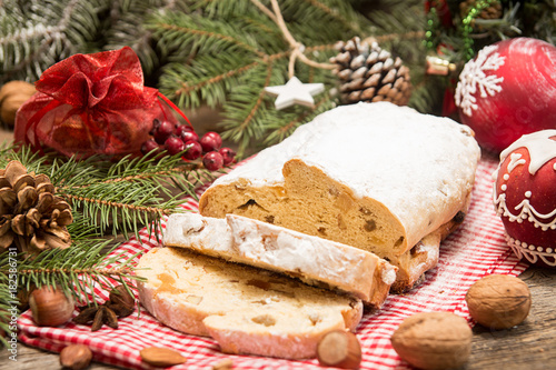 Traditional Christmas dresden cake stollen with candied fruits and almonds. Christmas New Year decoration.