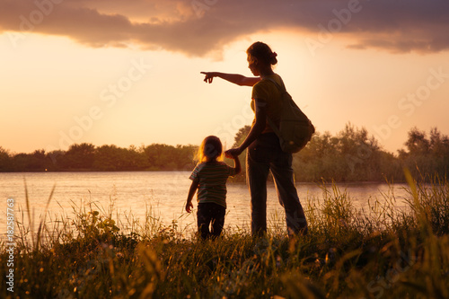 Mom and daughter at sunset