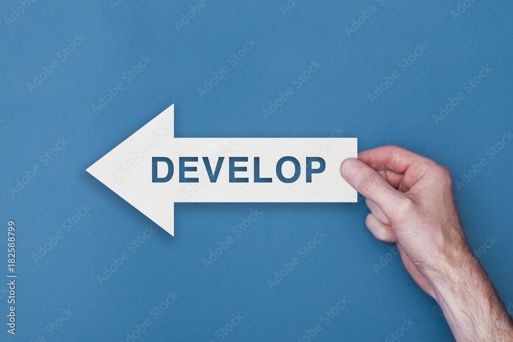 Develop arrow direction held on a blue background Develop arrow direction held on a blue background