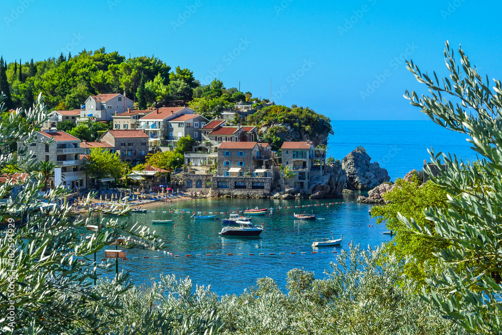 Coastal city. Small old houses with a tiled roof near the sea on the mountain. Montenegro. Adriatic Sea.