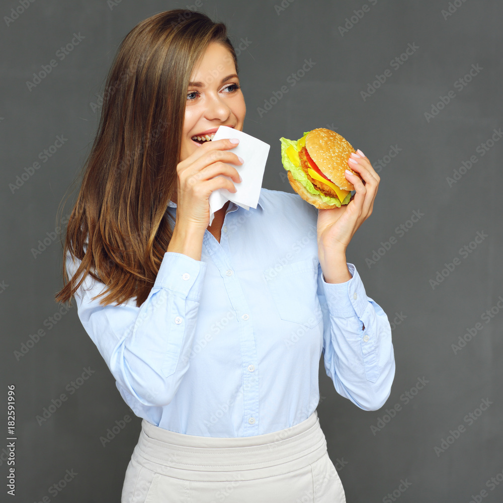 woman eating burger use paper tissue. woman eating burger use paper tissue.