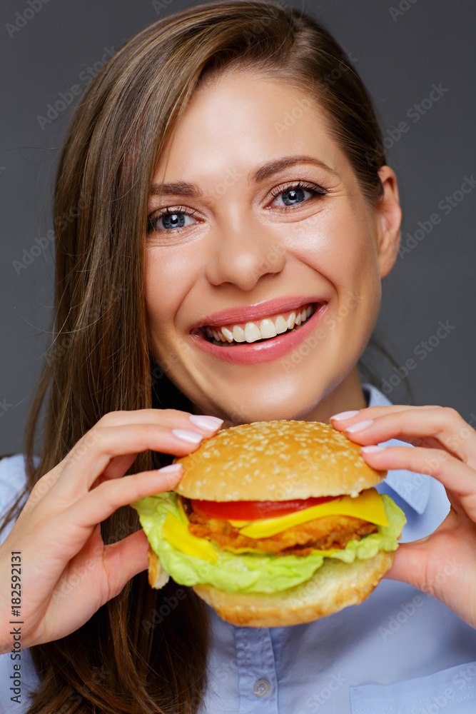 Smiling woman holding tasty burger. Smiling woman holding tasty burger.