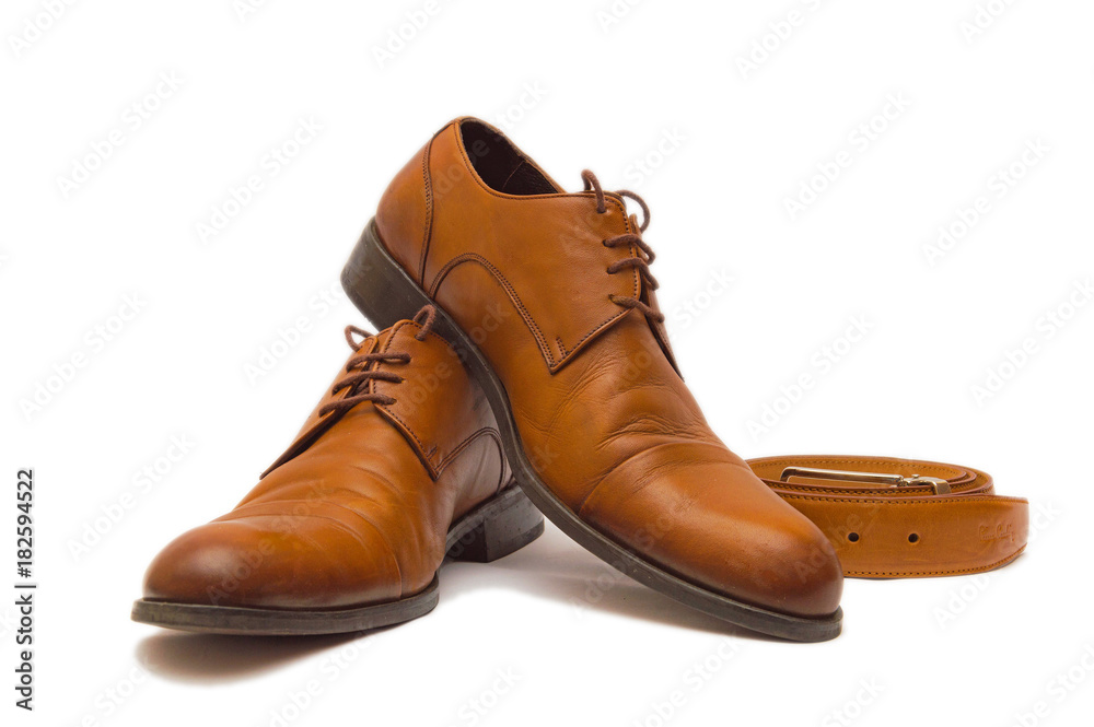 Men's red shoes and belt of leather isolated on white background Men's red shoes and belt of leather isolated on white background