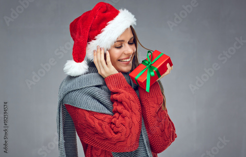 Christmas style portrait of happy woman holding red gift box