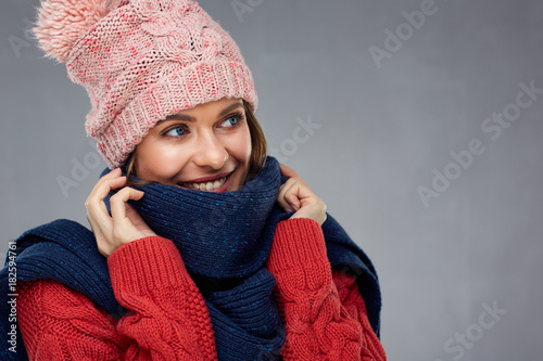 Close up face portrait of smiling woman wearing winter warm clothes.
