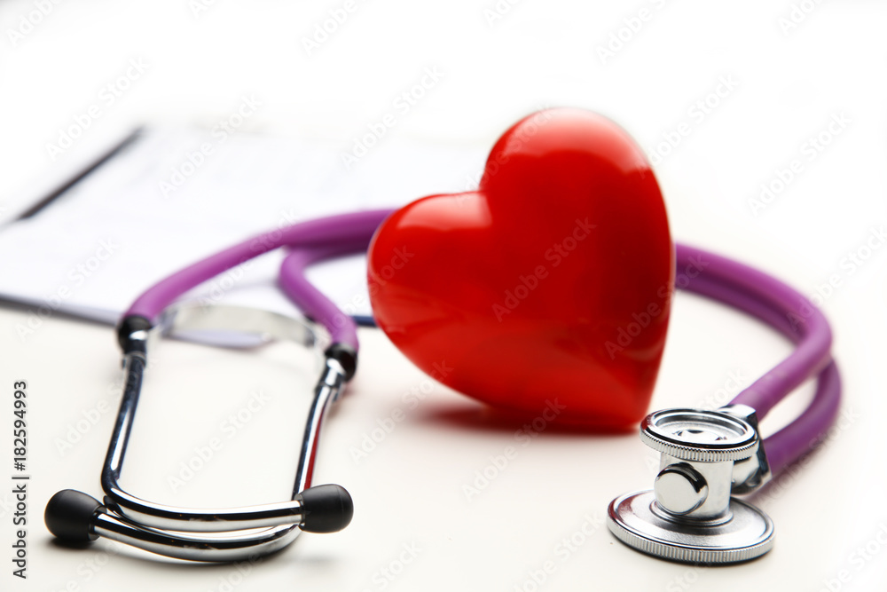 Heart with a medical stethoscope, isolated on wooden background Heart with a medical stethoscope, isolated on wooden background