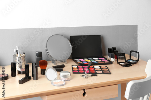 Cosmetic set on wooden dressing table