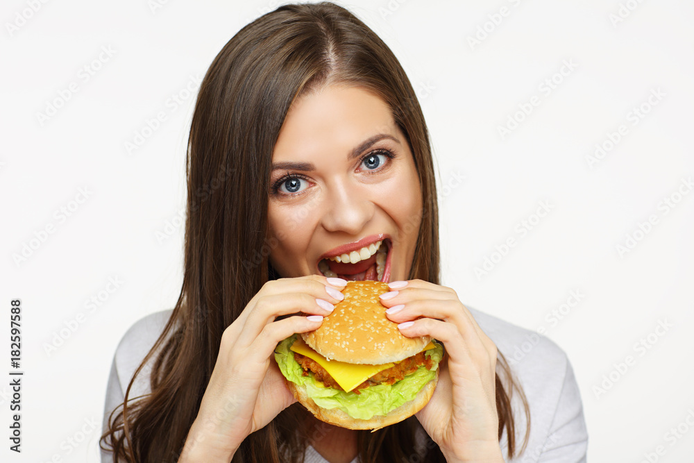 face portrait of woman eating fast food burger.