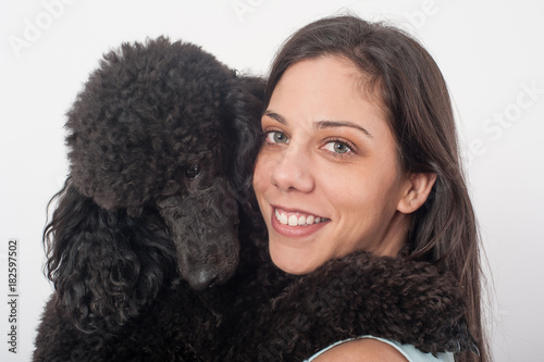 Portrait of a beautiful young woman hugging her beautiful dog
