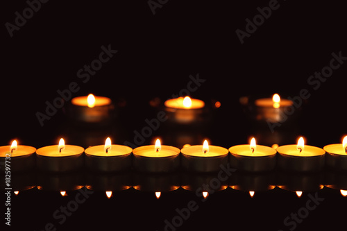 Burning candles on dark background