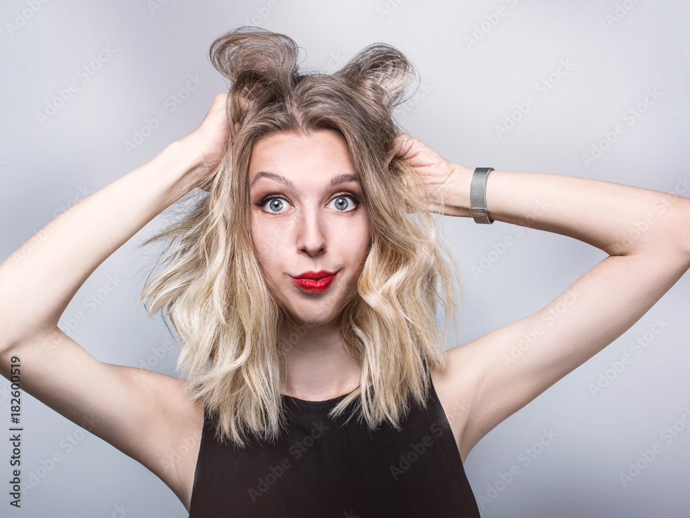Portrait of crazy young woman shouting and holding hair Portrait of crazy young woman shouting and holding hair