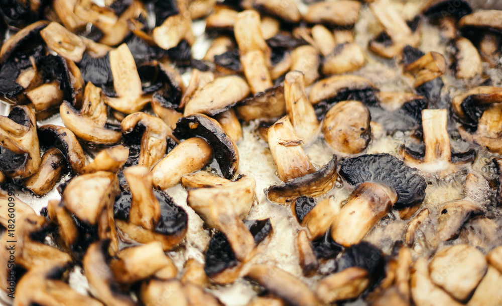 Champignons fry on a large baking sheet.