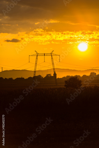 Sunset clouds and electric pylon