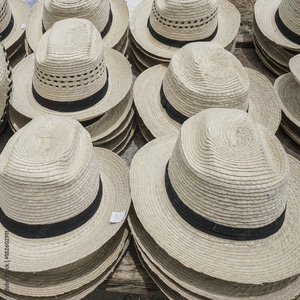 Handmade straw hats as a background