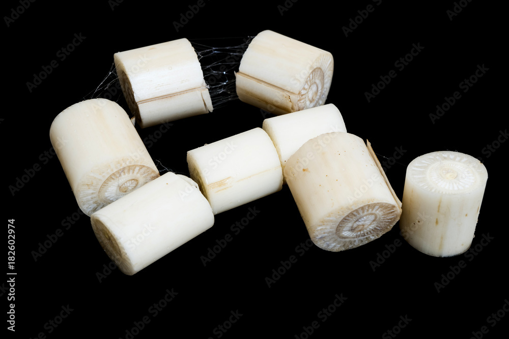 Fototapeta premium Banana stalk pith, The core of a banana trees sliced on a black background.