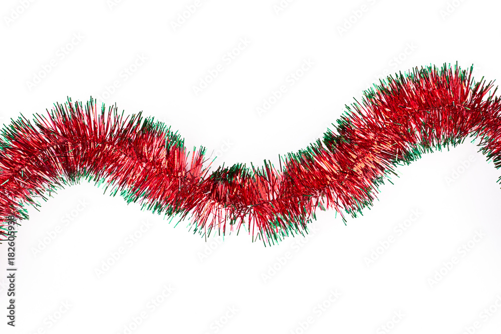 Red and green Christmas tinsel for decorations. Two-colour bright garland for Christmas holiday, isolated on white background. Red and green Christmas tinsel for decorations. Two-colour bright garland for Christmas holiday, isolated on white background.