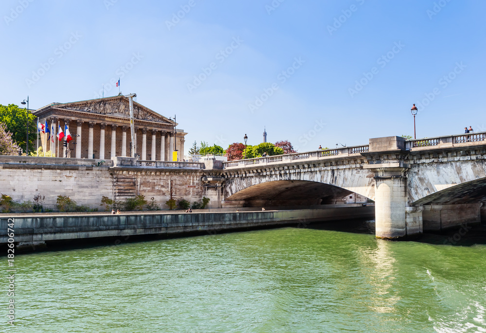 The National Assembly palace (Palais Bourbon) a government building located, on the left bank of the Seine. View from the water. Paris. France The National Assembly palace (Palais Bourbon) a government building located, on the left bank of the Seine. View from the water. Paris. France