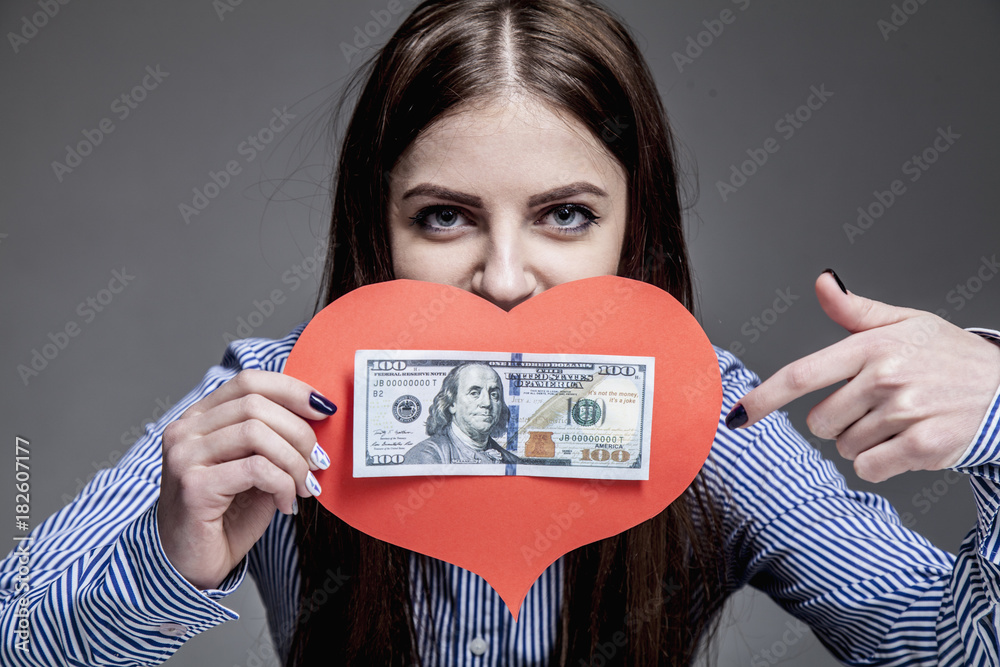 I love money! Beautiful business woman holding heart and cash as symbol of love for Dollars. (Purposefulness, motivation, wealth, success, freedom concept) I love money! Beautiful business woman holding heart and cash as symbol of love for Dollars. (Purposefulness, motivation, wealth, success, freedom concept)