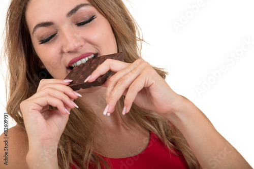 health  people  food and beauty concept - Lovely smiling teenage girl eating chocolate