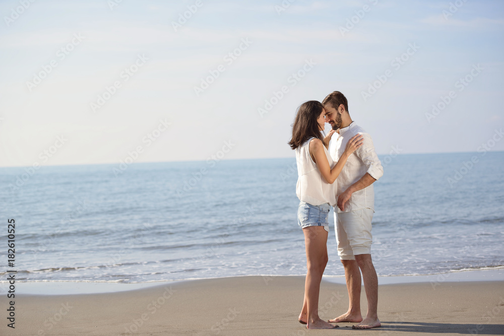 Romantic young couple on the beach kissing. Romantic young couple on the beach kissing.