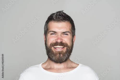 Guy or bearded man on grey background.