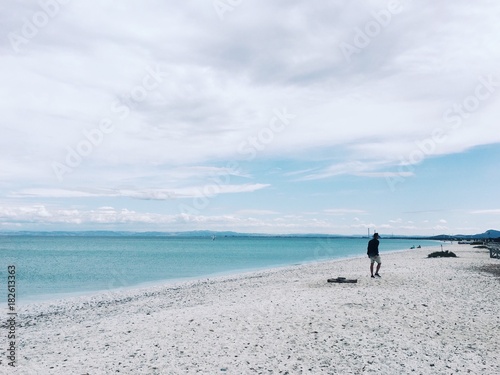 man walking by the beach in Sardinia, Italy