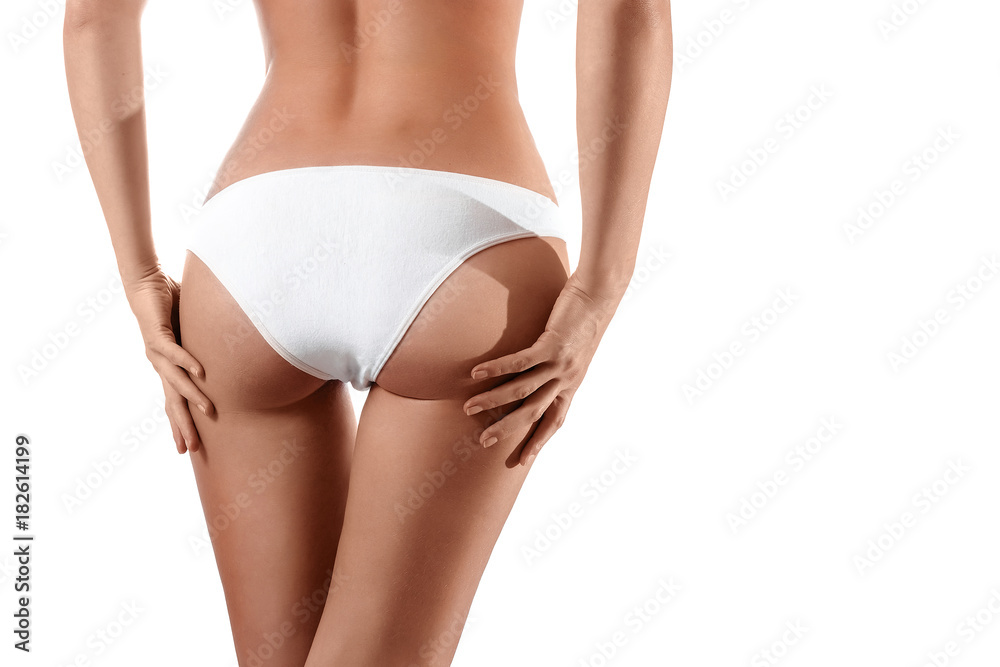 Perfect female body, buttocks close-up in white underwear, isolated on white background. The concept of beauty, plastic surgery.
