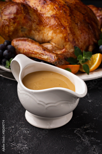 Homemade gravy in a sauce dish with turkey