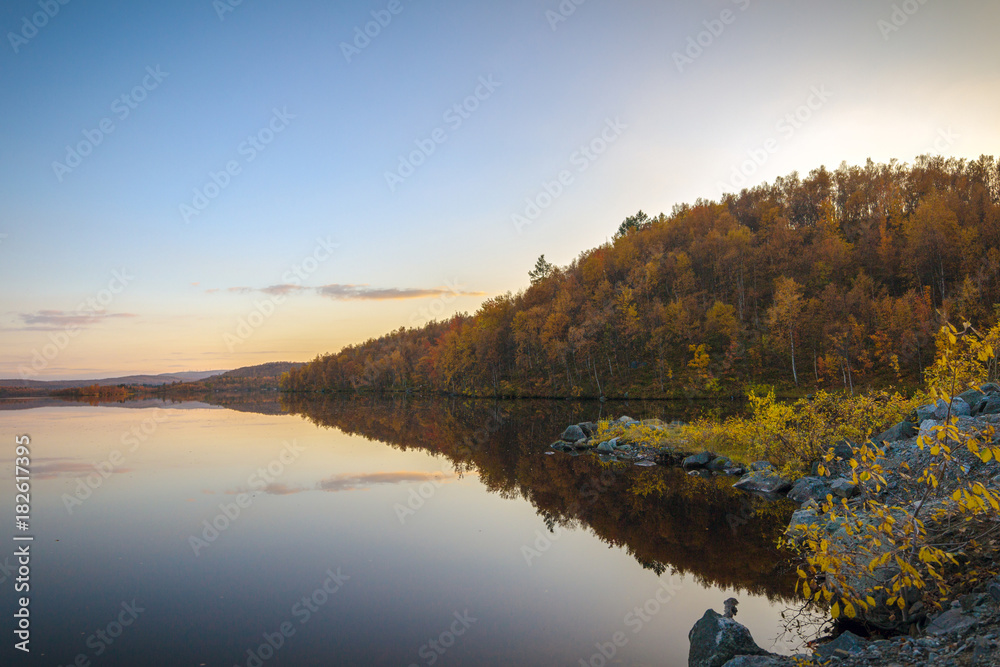 Autumn landscape.Lake in the autumn forest at sunset
