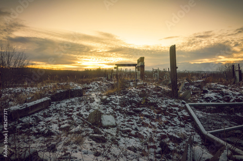 Nuclear winter.Remains of buildings covered with snow at sunset