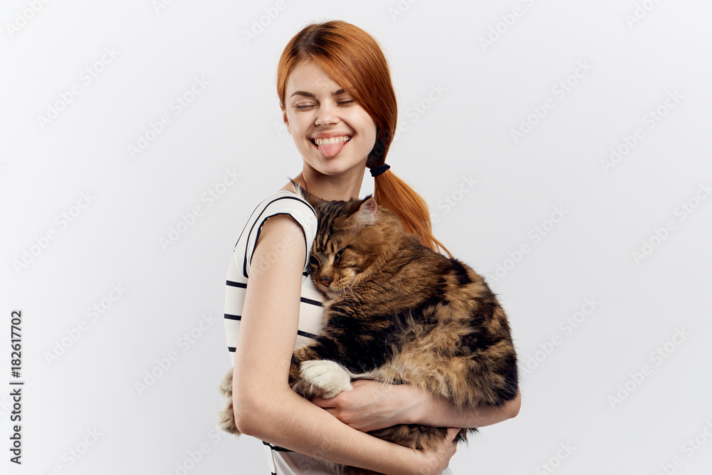 red-haired happy girl holding fluffy cat