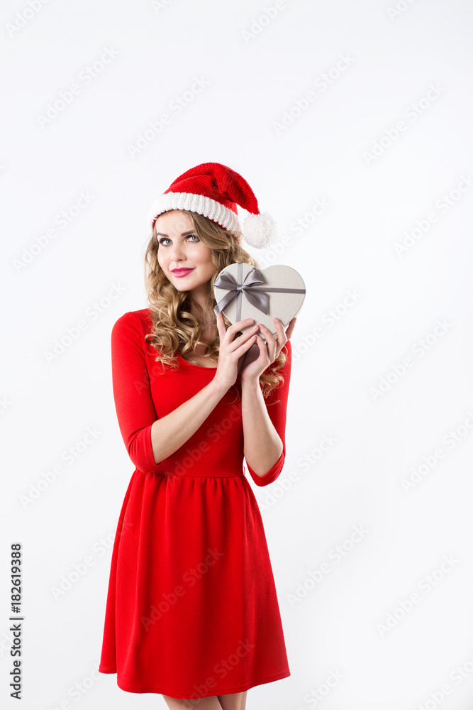 Portrait of attractive smiling woman blond in santa's hat and red dress isolated on white. Portrait of attractive smiling woman blond in santa's hat and red dress isolated on white.