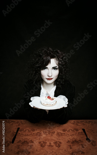 Girl with cherry fancy cake photo