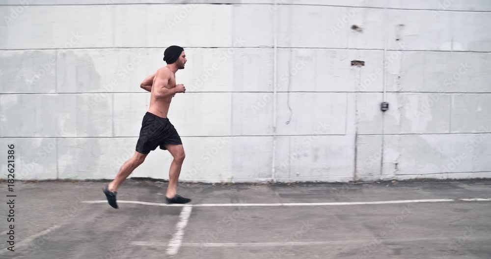 Athletic male working out in an empty parking lot. Crossfit. Slow Motion. Athletic male working out in an empty parking lot. Crossfit. Slow Motion.
