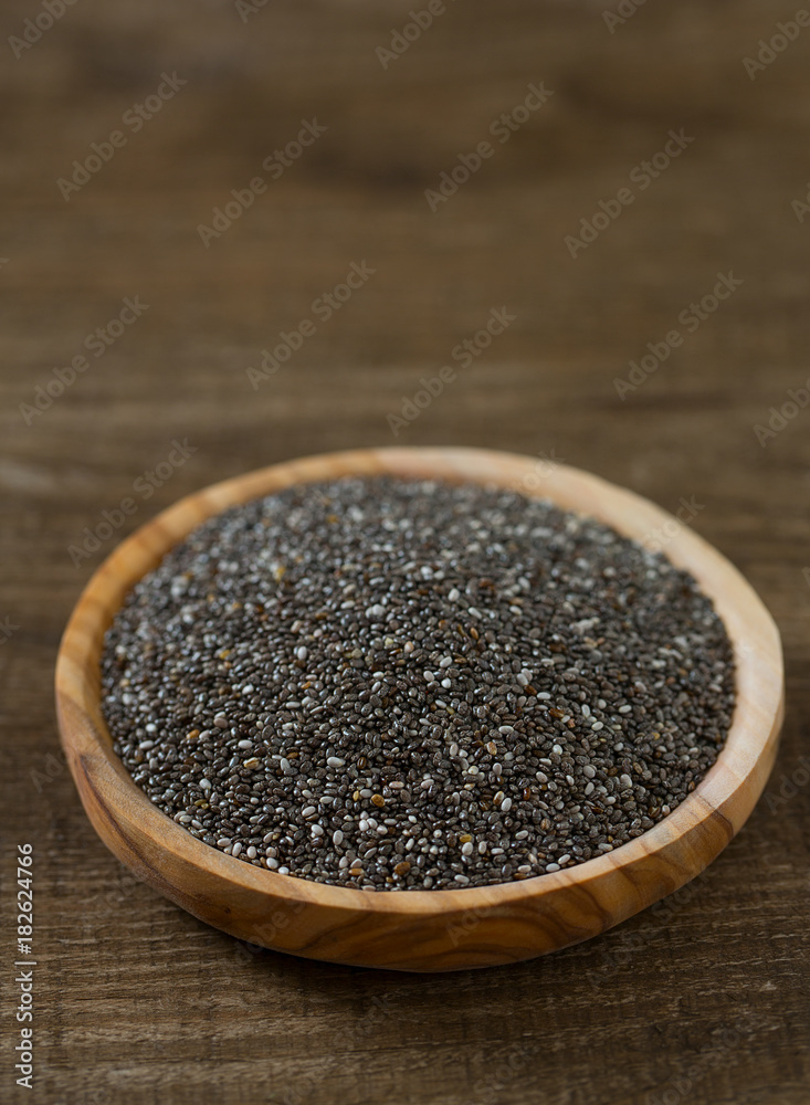 Chia seeds on a wooden surface Chia seeds on a wooden surface