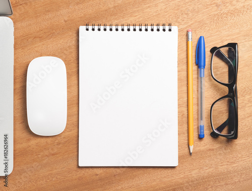 Business essentials. Top view of spiral blank notebook.