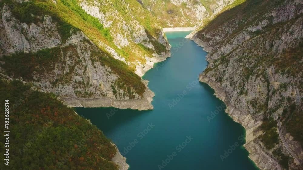 Sunlight and shadow on steep slopes in canyon of Piva river. Aerial of Montenegro mountains Sunlight and shadow on steep slopes in canyon of Piva river. Aerial of Montenegro mountains
