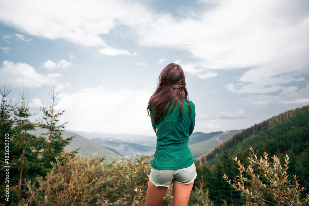 Naklejka premium Outdoor close up portrait stylish hipster girl behind amazing mountains landscapes,girl in sportswear, sexy model, girl hiking
