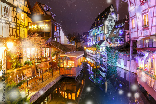 Traditional Alsatian half-timbered houses in Petite Venise or little Venice  old town of Colmar  decorated and illuminated at snowy christmas night  Alsace  France