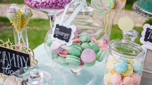 Details of a tasty candy bar with jugs of sweets, cookies and marshmallows, Candy, waffles, cookies and macaroons , sweets concept on Children's birthday