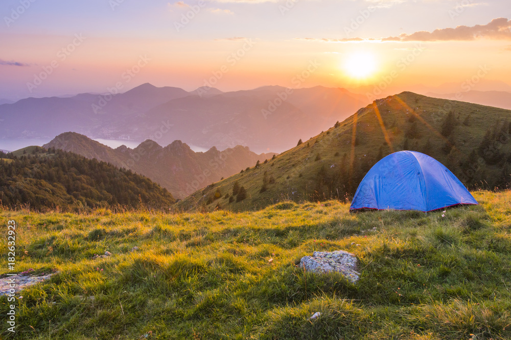 Camping outdoor with a tent with lake Iseo and Montisola at sunset, Brescia province, Lombardy district, Italy