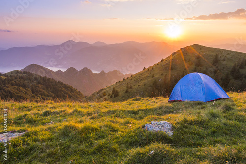 Camping outdoor with a tent with lake Iseo and Montisola at sunset, Brescia province, Lombardy district, Italy photo