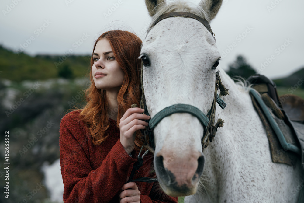 Obraz premium young woman with a horse walks on nature, travel, fresh air