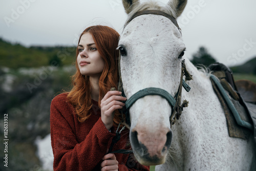 Fototapeta Naklejka Na Ścianę i Meble -  young woman with a horse walks on nature, travel, fresh air