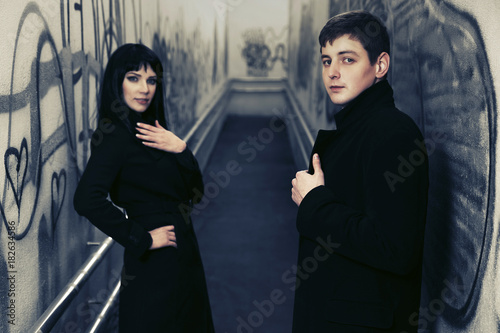 Young fashion couple in underground tunnel