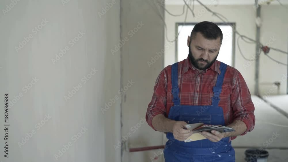 Young male worker checking, choosing paint from palette for new home
Young male worker checking, choosing paint from palette for new home